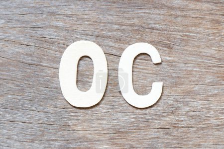 Photo for Alphabet letter in word OC (Abbreviation of opportunity cost or original content, character) on wood background - Royalty Free Image