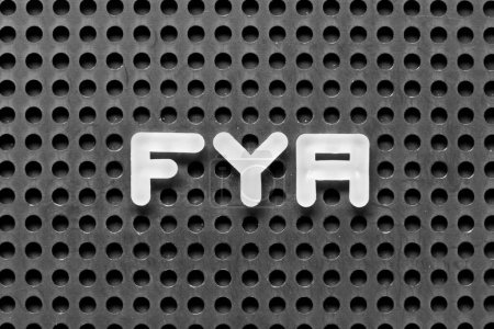 Foto de Letra del alfabeto blanco en la palabra FYA (Abreviatura de Para su acción o atención) sobre fondo negro pegboard - Imagen libre de derechos