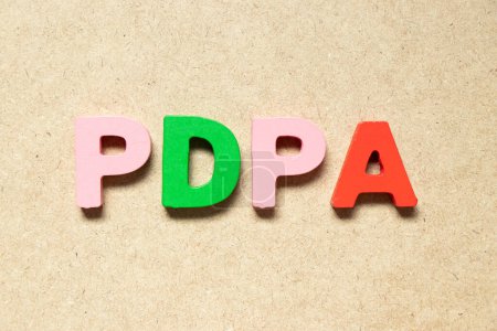 Téléchargez les photos : Color alphabet letter in word PDPA (Abbreviation of personal data protection act) on wood background - en image libre de droit