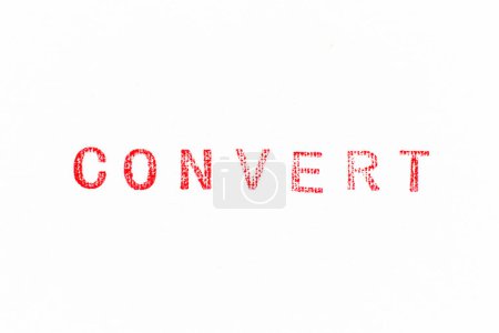 Foto de Red color rubber stamp in word convert on white paper background - Imagen libre de derechos