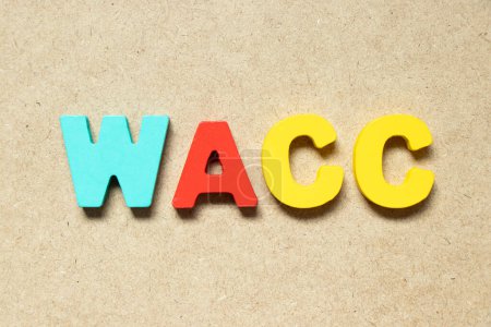 Foto de Color alphabet letter in word WACC (abbreviation of Weighted average cost of capital) on wood background - Imagen libre de derechos