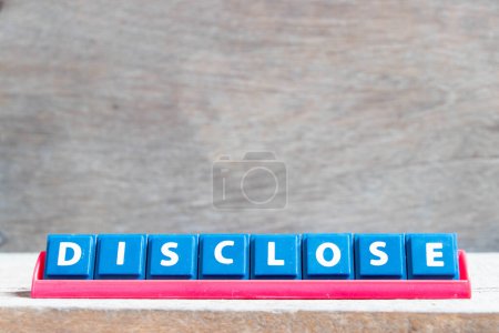 Téléchargez les photos : Tile alphabet letter with word disclose in red color rack on wood background - en image libre de droit