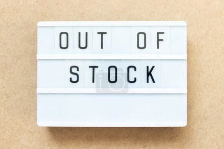 Photo for Lightbox with word out of stock on wood background - Royalty Free Image