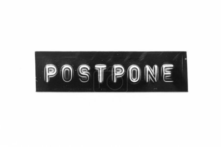 Photo for Black color banner that have embossed letter with word postpone on white paper background - Royalty Free Image