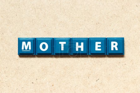 Téléchargez les photos : Carrelage lettre alphabet en mot mère sur fond de bois - en image libre de droit