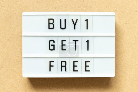 Photo for Lightbox with word buy 1 get 1 free on wood background - Royalty Free Image