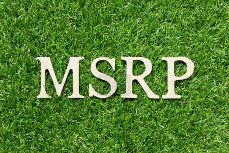 Photo for Wood letter in word MSRP (Abbreviation of manufacturer's suggested retail price) on green grass background - Royalty Free Image
