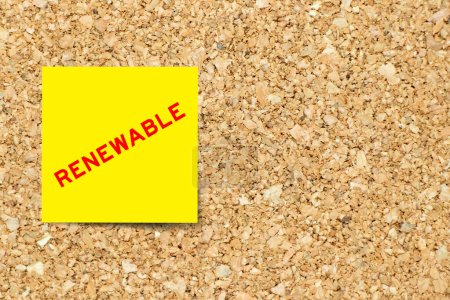 Photo for Yellow note paper with word renewable on cork board background with copy space - Royalty Free Image