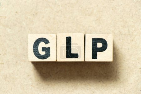 Foto de Alfabeto letra bloque en palabra BPL (Abreviatura de buenas prácticas de laboratorio) sobre fondo de madera - Imagen libre de derechos