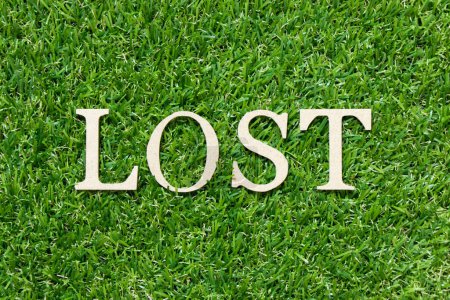 Photo for Wood letter in word lost on green grass background - Royalty Free Image