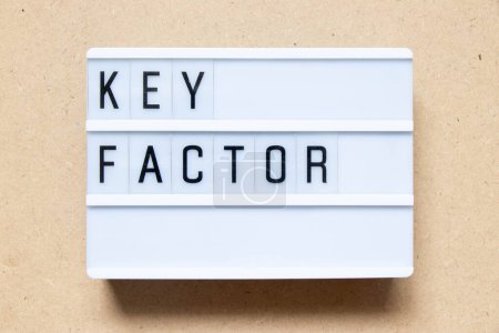 Photo for Lightbox with word key factor on wood background - Royalty Free Image
