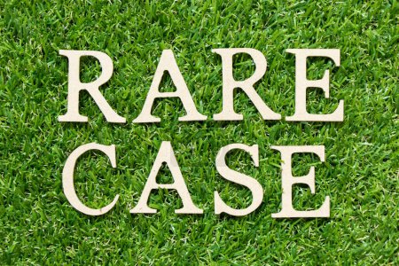 Wood letter in word rare case on green grass background