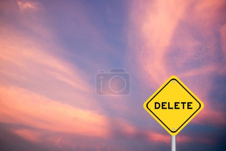 Yellow transportation sign with word delete on violet color sky background