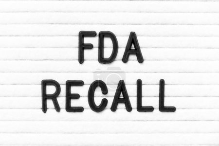 Black color letter in word FDA recall on white felt board background