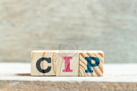 Alfabeto letra bloque en palabra CIP (Abreviatura de transporte y seguro pagado a, Proceso de mejora continua o Clean-in-place) sobre fondo de madera