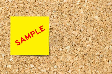 Yellow note paper with word sample on cork board background with copy space
