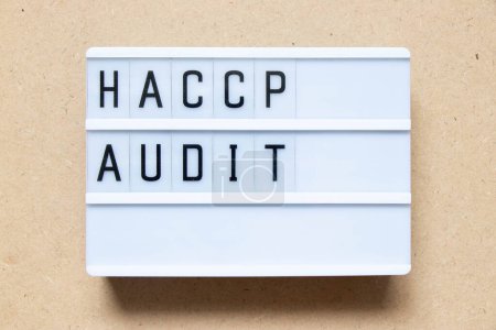 Photo for Lightbox with word HACCP (Hazard Analysis Critical Control Points) audit on wood background - Royalty Free Image