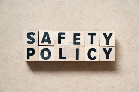 Alphabet letter block in word safety policy on wood background
