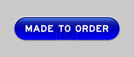 Ilustración de Botón de forma de cápsula de color azul con palabra hecha a pedido sobre fondo gris - Imagen libre de derechos