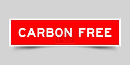 Red color square shape sticker label with word carbon free on gray background