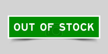 Green color square label sticker with word out of stock on gray background