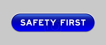 Ilustración de Botón de forma de cápsula de color azul con palabra seguridad primero sobre fondo gris - Imagen libre de derechos