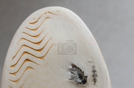 Téléchargez les photos : Through hole worn on the sole of sneakers - en image libre de droit