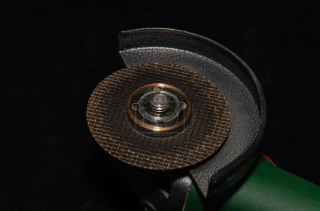 Photo for The master installs a disc on an angle grinder - Royalty Free Image