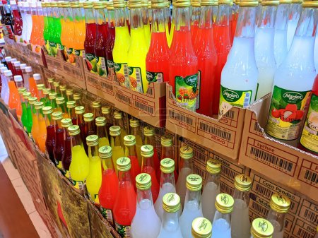 Photo for Close-up photo of neatly arranged syrup bottles in a supermarket, fruits bottled syrup - Royalty Free Image