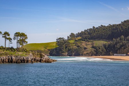 Photo for Lekeitio beach and little island of San Nicolas in Basque country, hills and forests around - Royalty Free Image