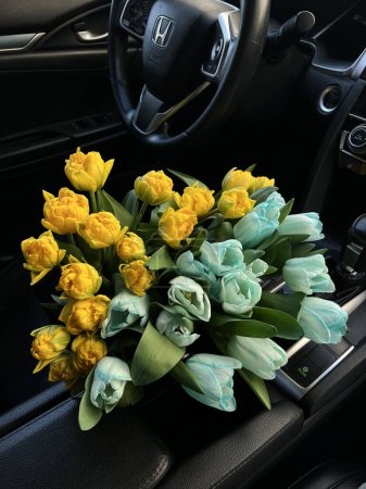 Beautiful bouquet of Ukrainian colorful flowers in the car
