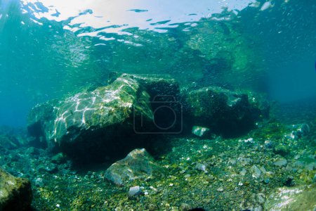 Large stones near the shore under seawater.
