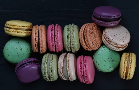 Sweet Symmetry: Top-Down View of Vibrant Macarons Popping Against a Sleek Black Backdrop