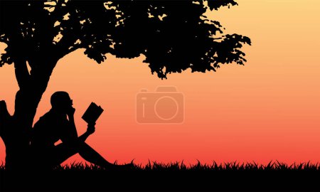 Frau liest Buch unter Baum im Park