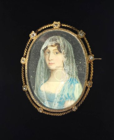 Photo for Vintage gold brooch with diamonds. Miniature painted on mother-of-pearl representing the portrait of a young woman wearing a white mantilla, from the 18th century. - Royalty Free Image