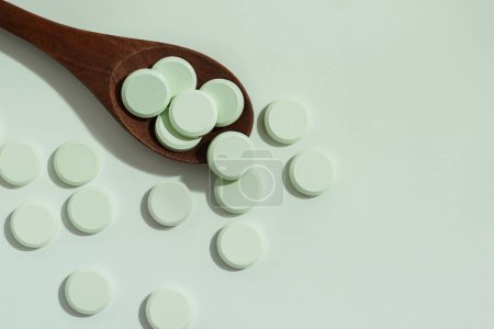 Photo for Medicine pills with wooden spoon on - Royalty Free Image