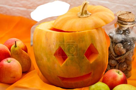 Photo for Carved pumpkin for halloween lies on a table at home - Royalty Free Image