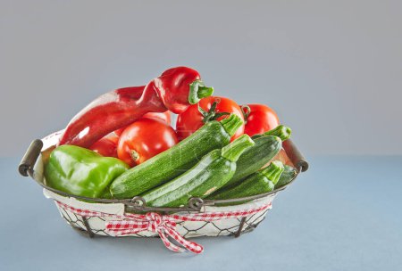Photo for Zucchini, bell peppers, and tomatoes on rustic wood - Royalty Free Image
