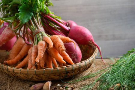 Photo for Basket of vibrant veggies baby carrots and radishes for a healthy treat - Royalty Free Image
