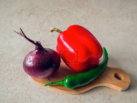 Photo for Colorful assortment of fresh red and green peppers on a rustic wooden table - Royalty Free Image