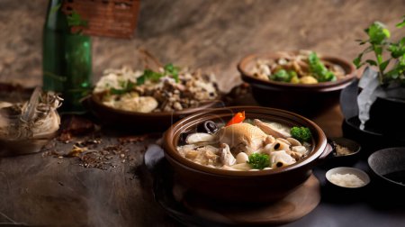 Photo for Wholesome chicken soup with a variety of meats on the table - Royalty Free Image