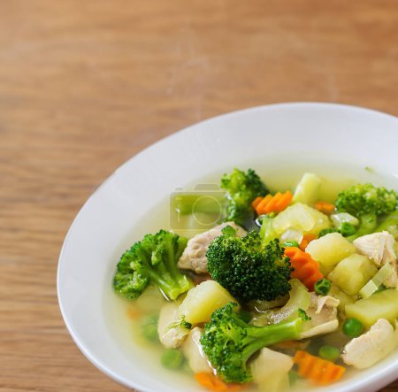 Photo for Hearty chicken soup with veggies on rustic wood - Royalty Free Image