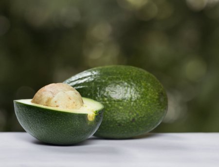 Photo for A series of vibrant and fresh green avocados from different angles - Royalty Free Image