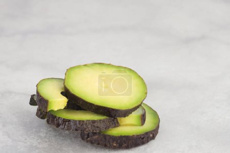 Photo for Healthy half-cut avocado on plate, fresh and vibrant - Royalty Free Image