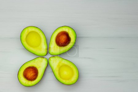 Photo for Avocado with seed, adorned with a flower pattern - Royalty Free Image