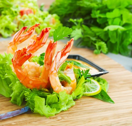 Photo for Green salad topped with succulent shrimp - Royalty Free Image