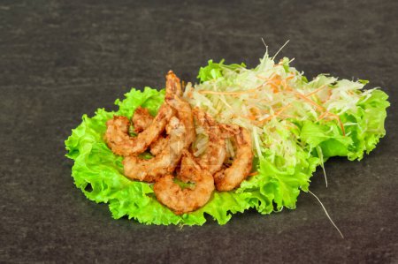 Photo for Crispy fried shrimps with lettuce served on a white plate - Royalty Free Image