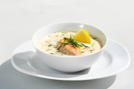 Photo for Creamy fish soup on a white isolated background, captured in food photography. - Royalty Free Image