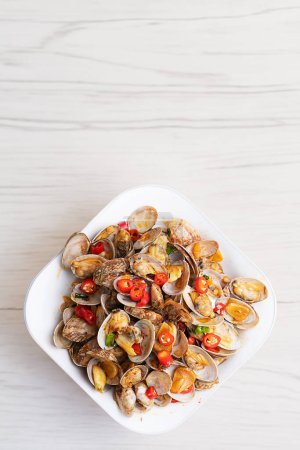 Photo for Spicy clam dish served with a dash of lemon - Royalty Free Image