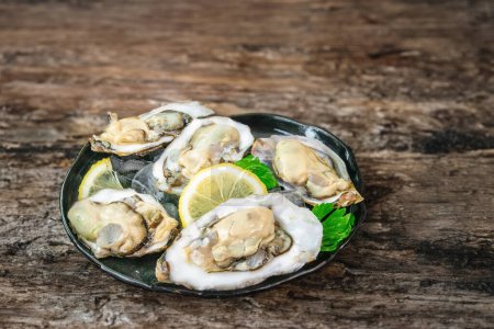 Photo for A fresh start with morning oysters and zesty lemon - Royalty Free Image